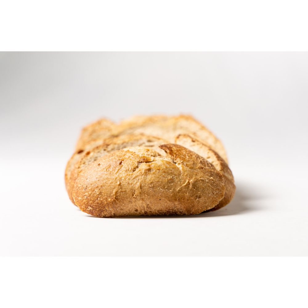 Photo of slices of an entire Mountain Loaf leaning onto eachother, starting with the end slice of the bread.